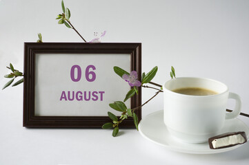 Day of month.Calendar,flowering rhododendron branch and cup of coffee