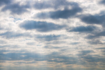 Dramatic moody cloudscape, with beams of sun shining through the clouds, spring sky, UK, Kent