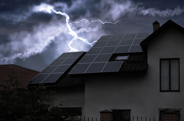 Dark cloudy sky with lightning over house. Stormy weather