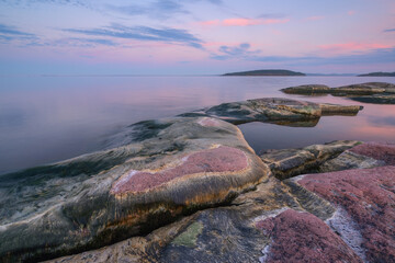 Rocky shore of the lake at dawn, lake Ladoga