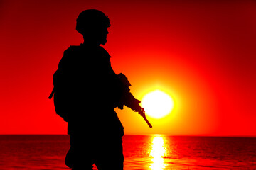 Silhouette of army special forces rifleman, Marines, coast guard or anti-terrorist squad soldier in...