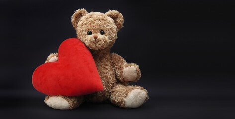 gift card, teddy bear with red heart isolated on black background