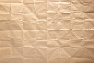 Wrinkled paper texture as background texture. Folded craft paper