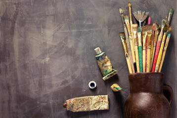 Paint brush and tubes on abstract table background texture. Art painter tools concept - Powered by Adobe