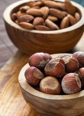 snack food concept, nuts in wooden plates on the table