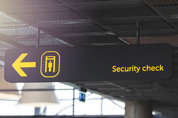 Airport informaction signs. Arrow on information screen leading to security check