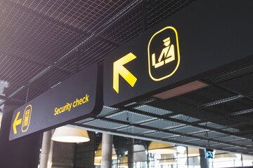 Airport informaction signs. Arrow on information screen leading to security check