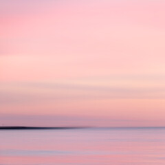 abstract landscape of sea. texture water, sky and sand in blurry motion in tropical sunset colors