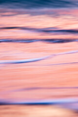 abstract landscape of sea. texture water, sky and sand in blurry motion in tropical sunset colors