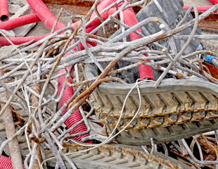 Scrap yard: rubber tracks, steel armor with rust and flexible hoses for abandoned electrical cables.