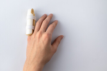 medical splint on a broken finger, on a white background. Medical assistance in case of injury