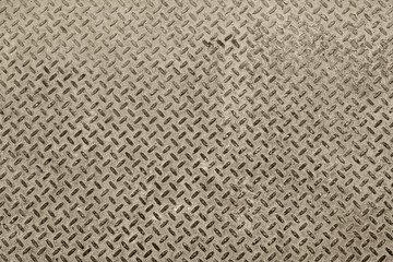 Fototapeta premium A metal plate with small applied periodic bulges, is used as a support on the surface to reduce slipping when people walk.
