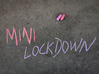 The inscription text on the grey board, Mini Lockdown . Using color chalk pieces.