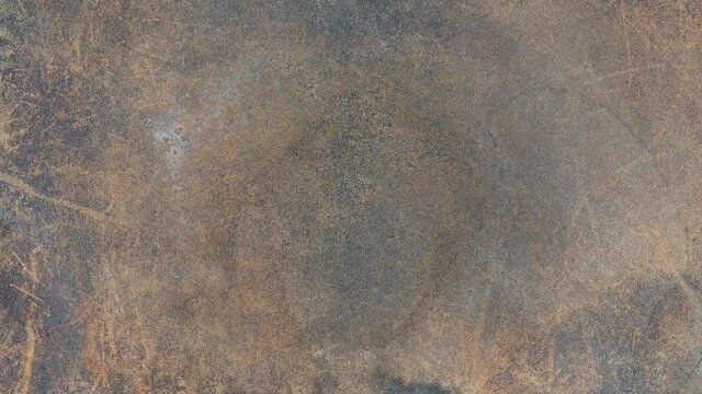 Top view flat lay 4k stock video footage of old worn abstract brown texture with scratches and burnt spots. Abstract grunge background