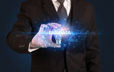 Businessman holding a light bulb