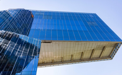 Modern and elegant glass building with blue reflections