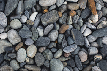 sea pebble stone background. grey, white and brown colors. view from above