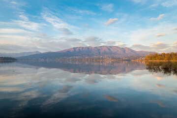 Stunning lake at sunset, north Italy. Lake Varese from Cazzago village, in the background the Campo dei Fiori massif. Famous because it hosts rowing competitions of national, european and world level