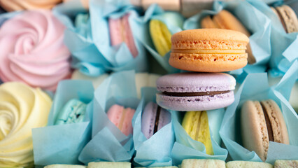Berry colored macaroons in a paper box. Macaroons, marshmallows, zephyr background. Confectionery box.