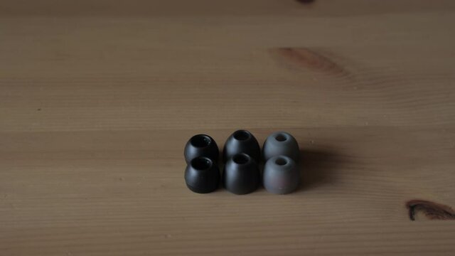 Set of silicone ear tips on wooden surface