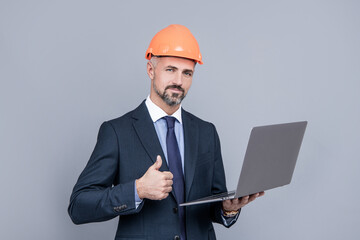 thumb up. agile business success. entrepreneur in helmet use pc. engineer hold computer.