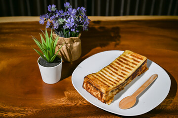 Bread toast close up view with decorative plant on wooden table
