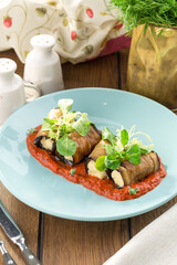 Fried eggplant slices stuffed with soft cheese and tomato sauce on the table