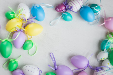 Pastel color plastic Easter eggs decoration on a light background
