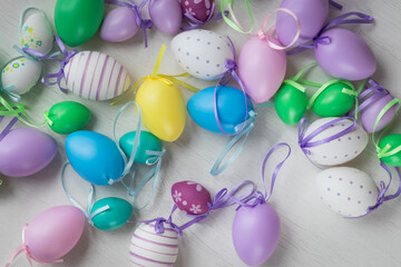 Pastel color plastic Easter eggs decoration on a light background