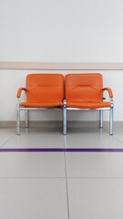 metal chairs with bright orange leather seats