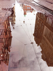 reflection of  houses in puddle