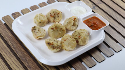 Veg steam momos. Momos stuffed with vegetables and then cooked and served with sauce