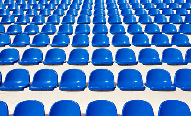 blue chairs in the stadium © Nina