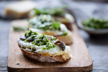 Crostini with mozzarella, anchovies and rocket pesto