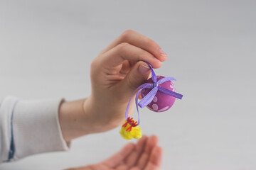 Boy with plastic Easter egg decoration on his hands 
