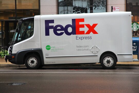 CHICAGO, USA - JUNE 26, 2013: Fedex electric vehisle delivers packages in Chicago. Fedex is one of largest package delivery companies worldwide.