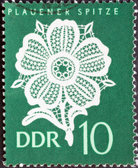 GERMANY, DDR - CIRCA 1966  : a postage stamp from Germany, GDR showing the handcrafted Plauen lace: flower pattern. green