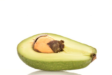 One half of a ripe avocado with a bone, close-up, isolated on white.