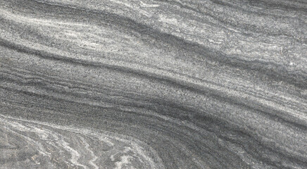 Fototapeta na wymiar Glatt geschliffene, graue Steinplatte mit abstraktem Muster in Nahaufnahme