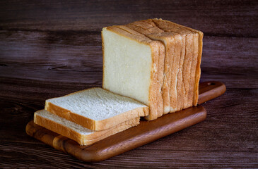  piece of bread lying on the wooden floor Dark wood background