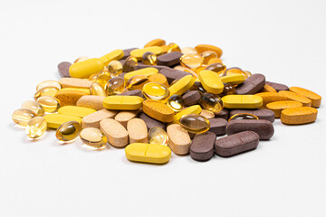 A pile of vitamins and medicine and fish oil on a isolated white background