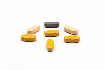 A pile of vitamins and medicine and fish oil on a isolated white background