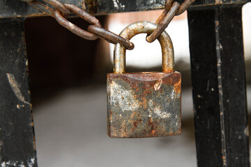 A gate closed with a padlock - focus on the padlock	
