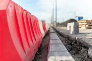 Replacement of curbs along the road and fencing made of plastic water barriers