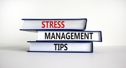 Stress management tips symbol. Books with words 'Stress management tips'. Beautiful white background. Psychological, business and stress management tips concept. Copy space.