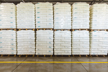 Warehousing of production materials and finished products. Pallets with bags close-up in a factory