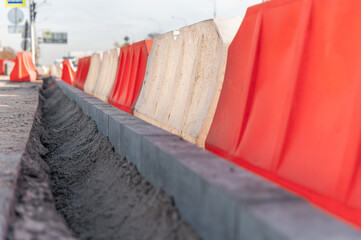 Replacement of curbs along the road and fencing made of plastic water barriers