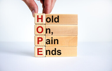 HOPE, hold on, pain ends symbol. Wooden cubes with words 'HOPE, hold on, pain ends. Beautiful white background, copy space. Business, motivational and HOPE, hold on, pain ends concept.