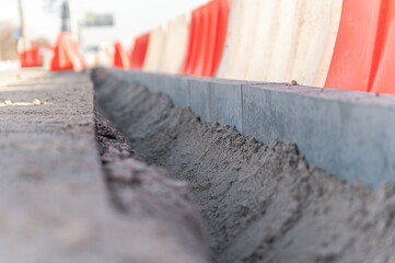 Replacement of curbs along the road and fencing made of plastic water barriers
