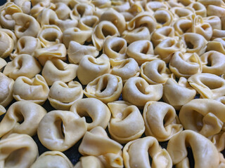 A close up top view shot of raw Tortellini with white mushrooms Texture Food photography